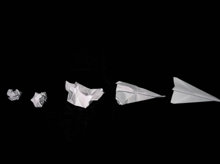 Sequence of crumpled sheets of paper becoming a paper aeroplane, symbolising strategic repositioning